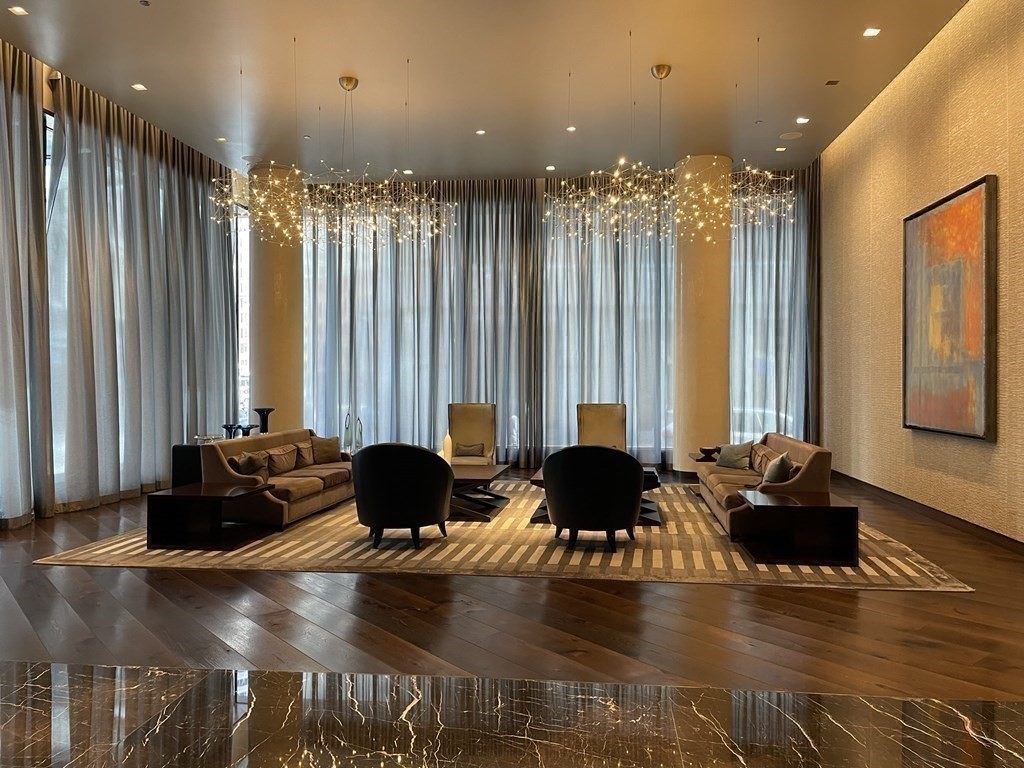 1 Franklin Street, Unit 4204 Boston, MA 02110 - Photo 15 of 37 a living room with furniture and a large window