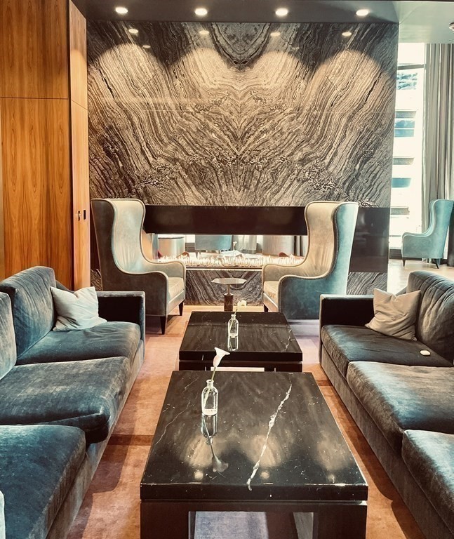 1 Franklin Street, Unit 4204 Boston, MA 02110 - Photo 17 of 37 a living room with furniture and a fireplace