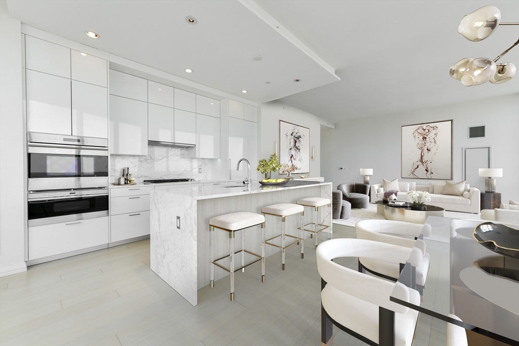 1 Franklin Street, Unit 4204 Boston, MA 02110 - Photo 4 of 37 a kitchen with white cabinets and stainless steel appliances