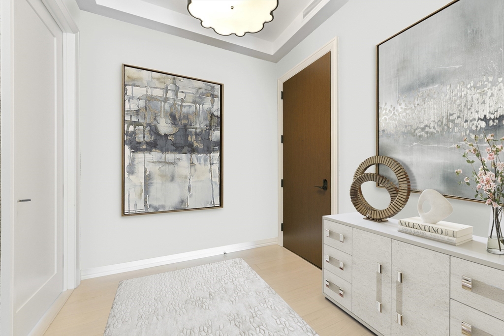 1 Franklin Street, Unit 4204 Boston, MA 02110 - Photo 5 of 37 a bathroom with a granite countertop sink a mirror and a shower