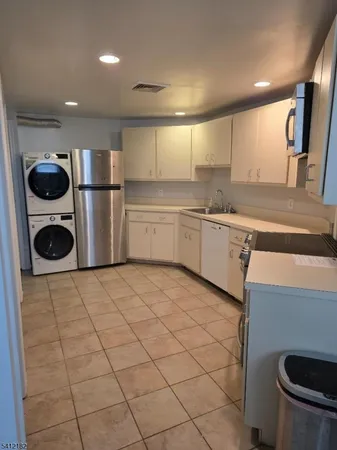 a kitchen with a sink cabinets and appliances