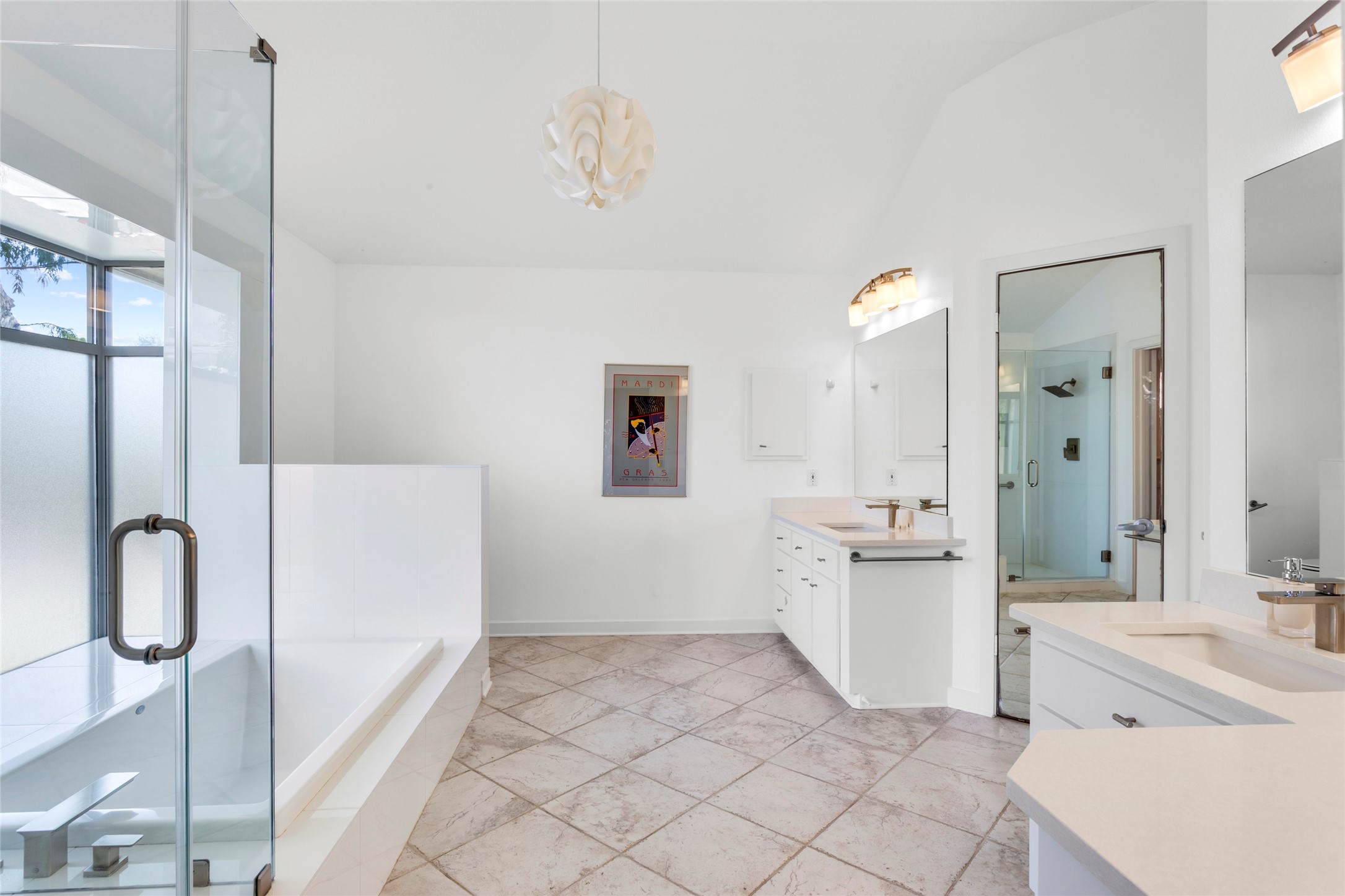 67 Harbor Lane Kemah, TX 77565 - Photo 17 of 47 This bright, spacious primary bathroom features a glass-enclosed shower, a large soaking tub, dual vanities, and ample natural light from frosted windows, creating a modern and relaxing atmosphere.