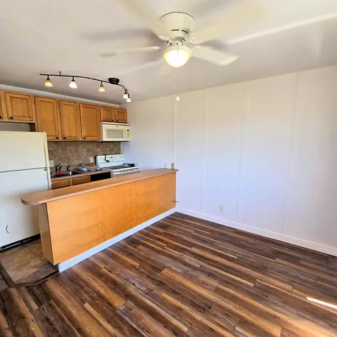 a view of kitchen with wooden floor and window