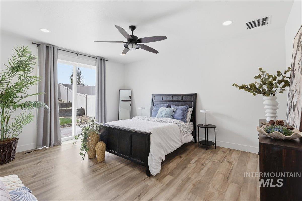 5897 West Riva Capri Street Meridian, ID 83646 - Photo 17 of 50 Spacious room featuring wood-finish flooring, a contemporary ceiling fan, and recessed lighting
