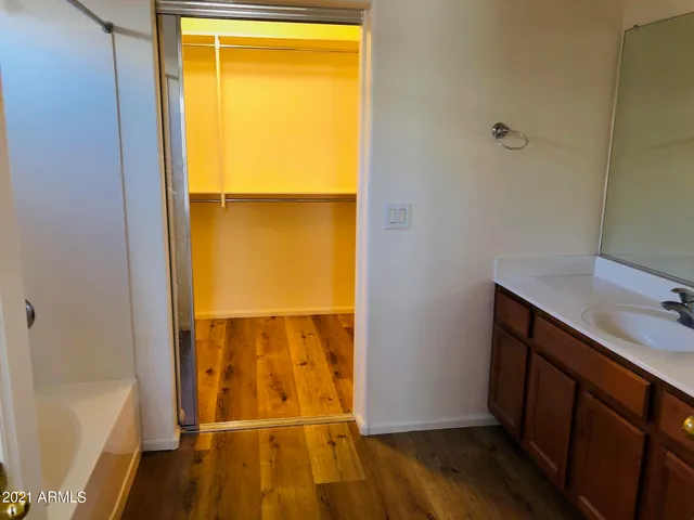 a view of a hallway view with wooden floor and staircase