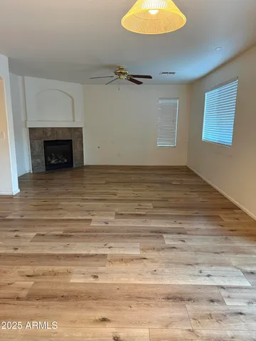 a view of a room with wooden floor and white walls