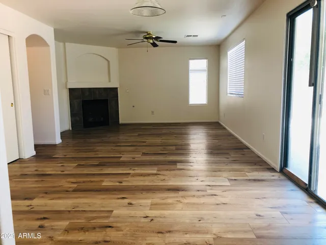 a view of a room with wooden floor and white walls