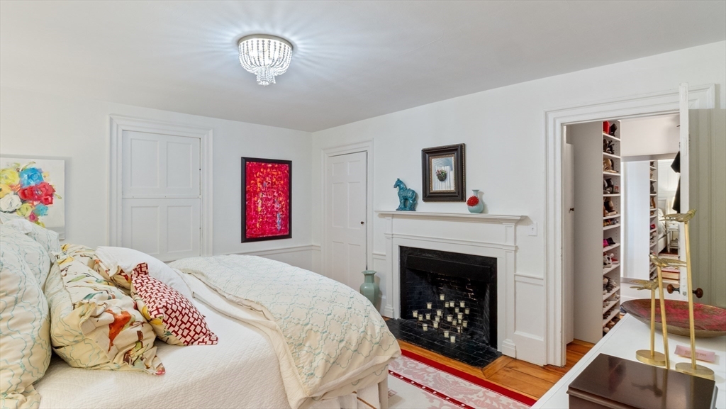 239 High Road Newbury, MA 01951 - Photo 19 of 42 a bedroom with a bed and a fireplace