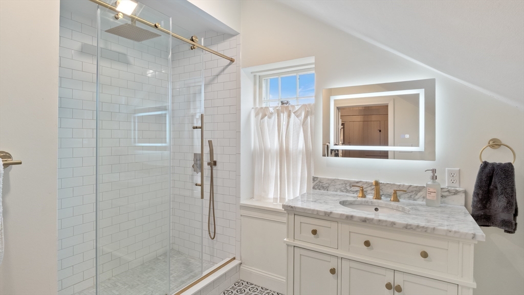 239 High Road Newbury, MA 01951 - Photo 32 of 42 a bathroom with a granite countertop sink a mirror and shower