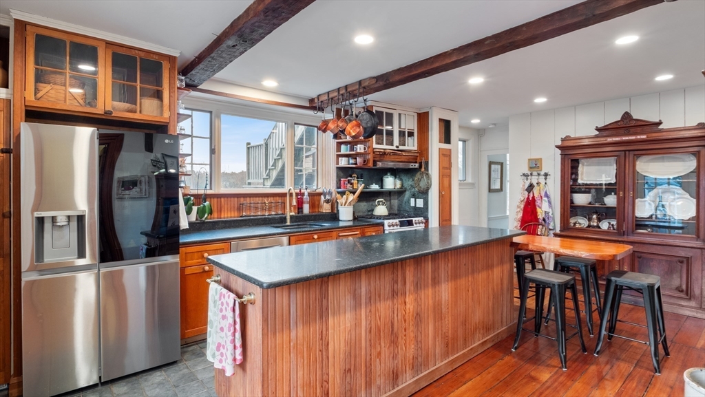 239 High Road Newbury, MA 01951 - Photo 8 of 42 a kitchen with stainless steel appliances granite countertop a refrigerator and a wooden cabinets