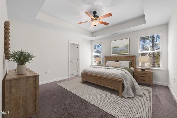 a bedroom with a bed window and a chandelier
