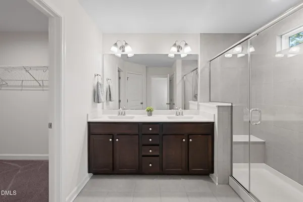 a bathroom with a shower sink and mirror