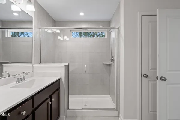 a bathroom with a double vanity sink and a mirror