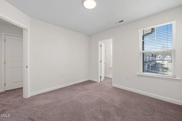 a bathroom with a double vanity sink toilet mirror and shower