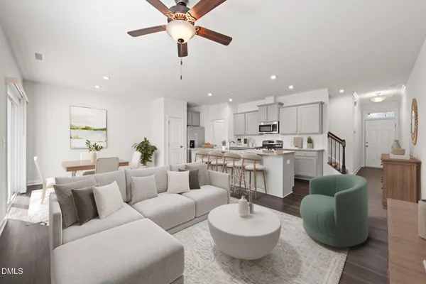 a living room with furniture kitchen and a view of kitchen
