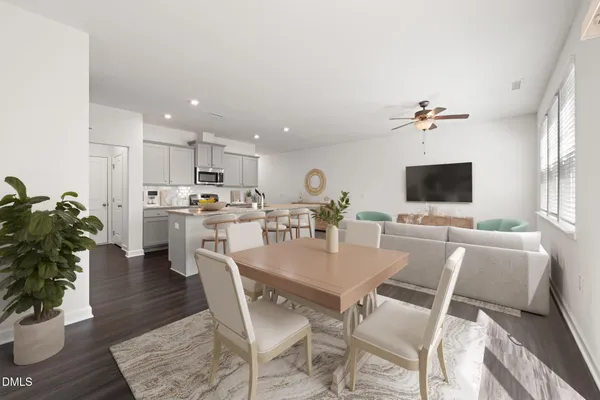 a view of kitchen with cabinets table and chairs