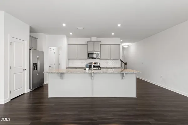 a view of kitchen with stainless steel appliances refrigerator sink and cabinets