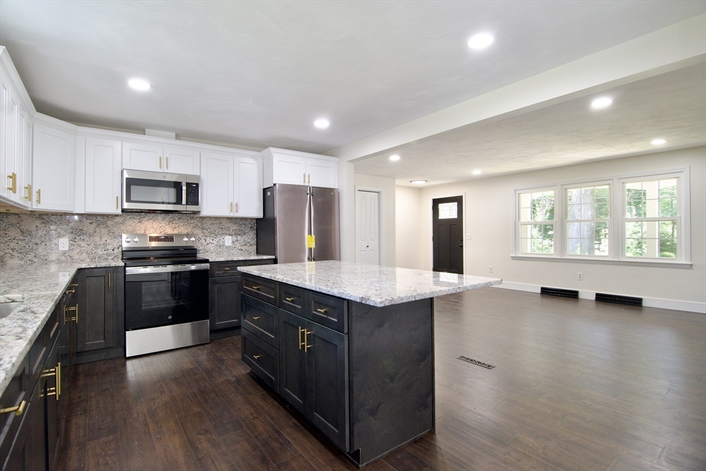 12 Dwight Street Hatfield, MA 01038 - Photo 13 of 42 a kitchen with stainless steel appliances granite countertop a stove a sink and a refrigerator