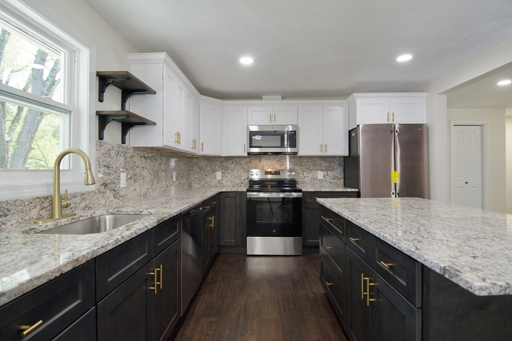 12 Dwight Street Hatfield, MA 01038 - Photo 16 of 42 a kitchen with kitchen island granite countertop a sink stove and refrigerator