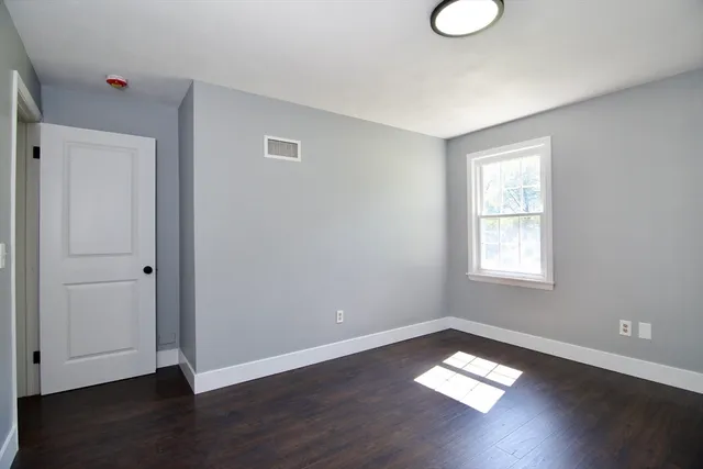 a view of a hallway with wooden floor and entryway