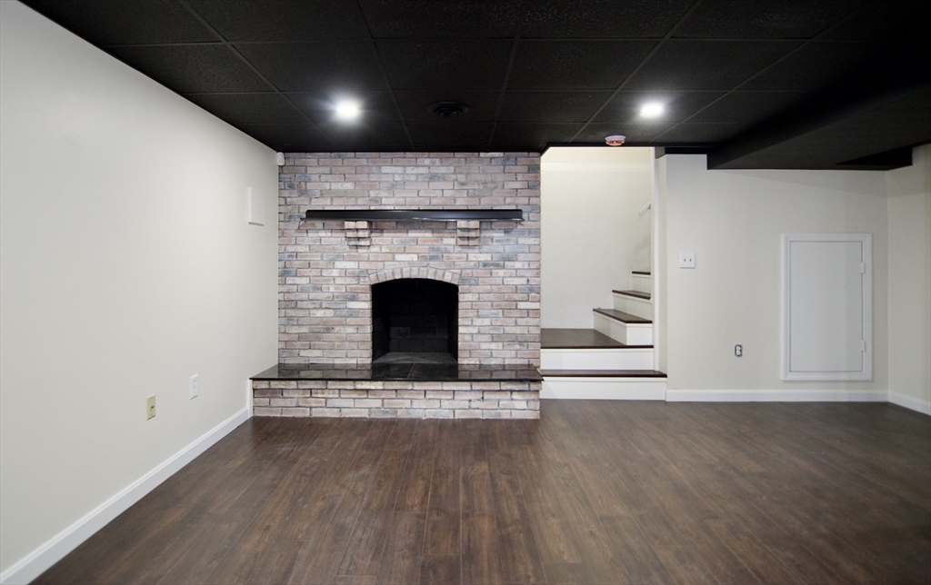 12 Dwight Street Hatfield, MA 01038 - Photo 31 of 42 a view of an empty room with wooden floor and a fireplace