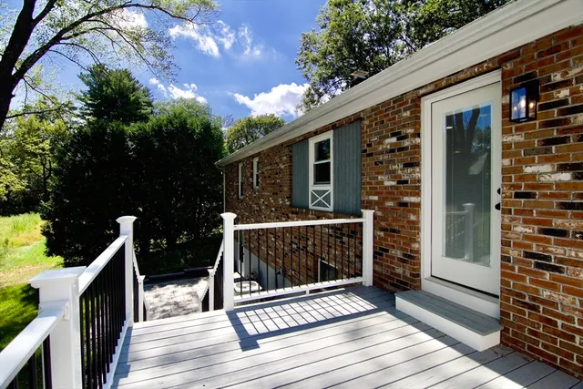 an empty room with wooden floor and fireplace