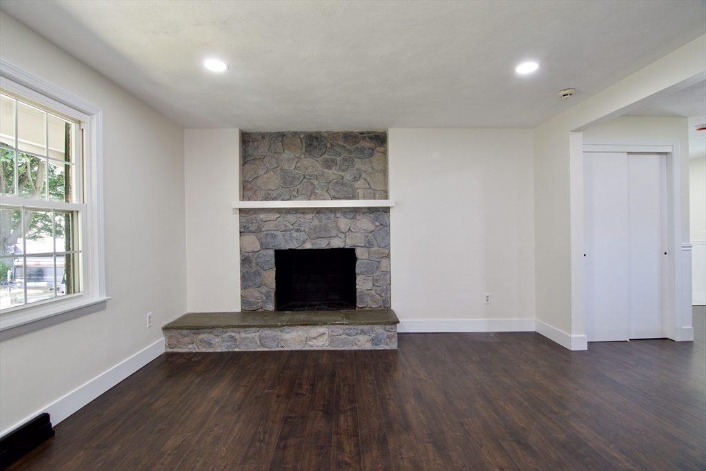 12 Dwight Street Hatfield, MA 01038 - Photo 9 of 42 an empty room with wooden floor and fireplace
