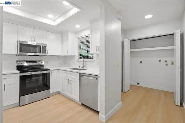 a kitchen with stainless steel appliances a stove sink and microwave