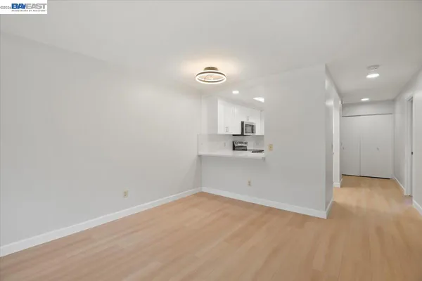 a view of a kitchen with a sink and a refrigerator