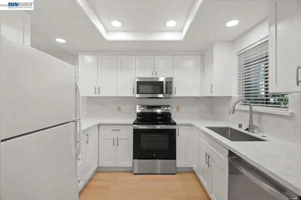 a kitchen with a sink stove and microwave