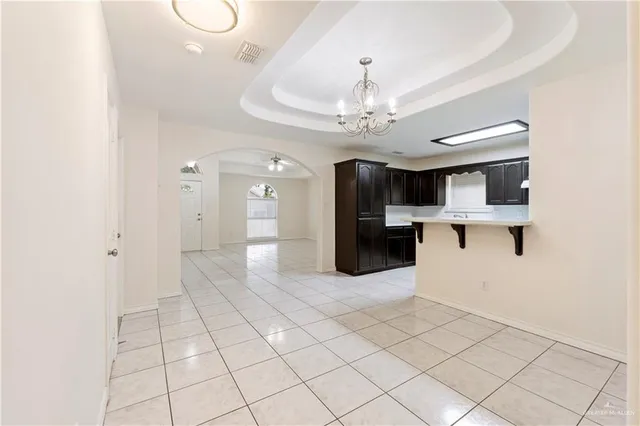 a view of entryway with kitchen and chandelier