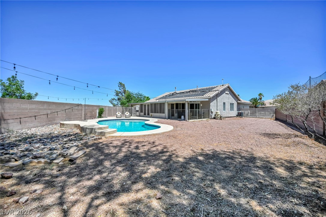 1234 Sunfire Street Henderson, NV 89014 - Photo 33 of 40 A private backyard oasis features an inviting pool and ample space for outdoor living.
