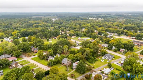 an aerial view of residential building with green space
