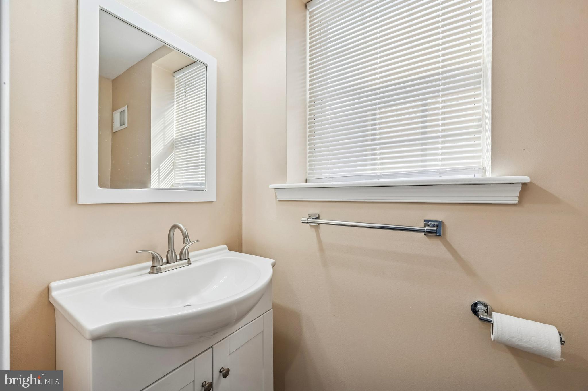 3730 Spring Garden Street Philadelphia, PA 19104 - Photo 17 of 24 a bathroom with a sink a vanity and a window