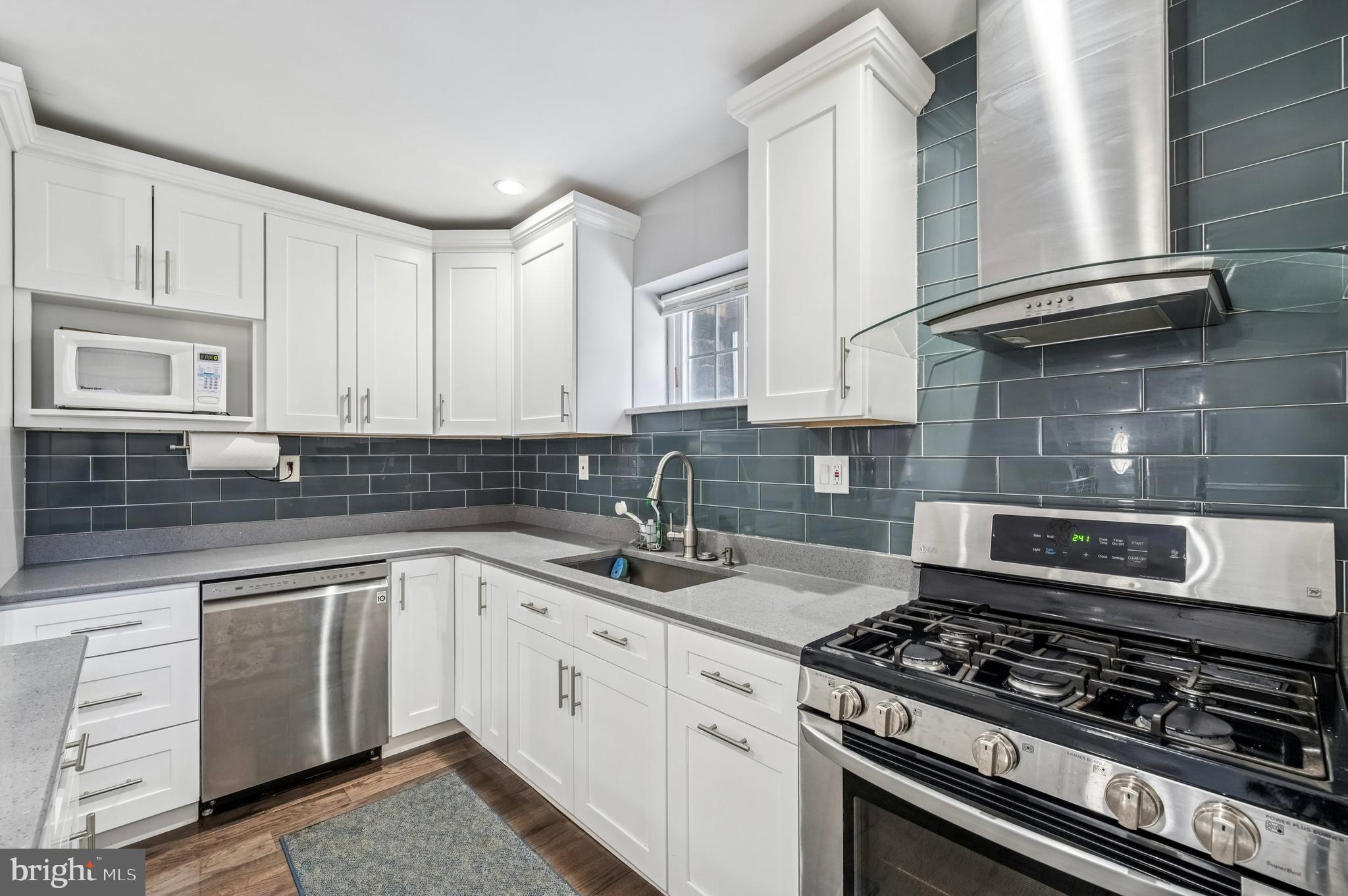 3730 Spring Garden Street Philadelphia, PA 19104 - Photo 6 of 24 a kitchen with white cabinets and appliances