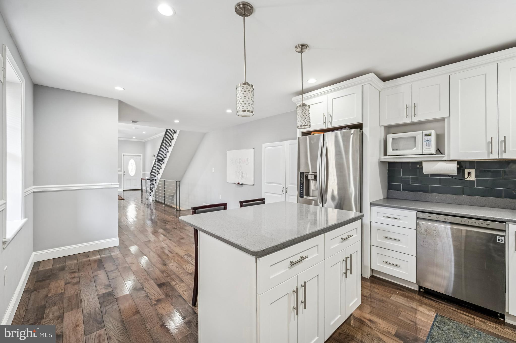 3730 Spring Garden Street Philadelphia, PA 19104 - Photo 8 of 24 a kitchen with white cabinets and stainless steel appliances