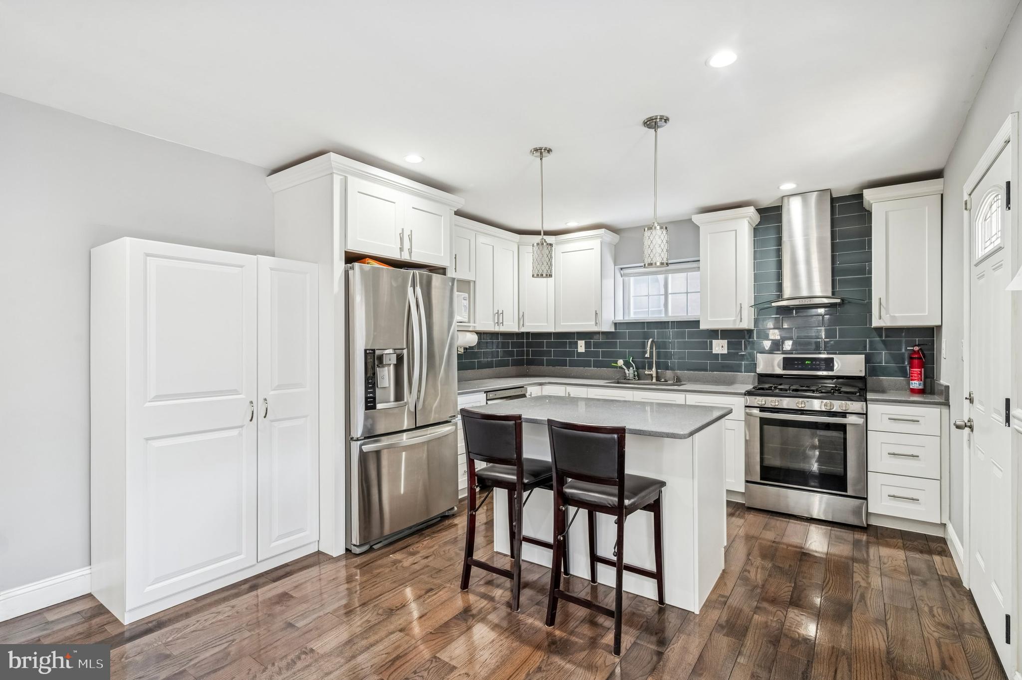 3730 Spring Garden Street Philadelphia, PA 19104 - Photo 10 of 24 a kitchen with granite countertop a refrigerator stove top oven and sink