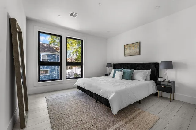 a large bedroom with a large bed and a large window