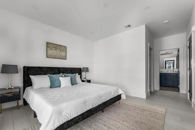 a bedroom with bed and painting on the wall