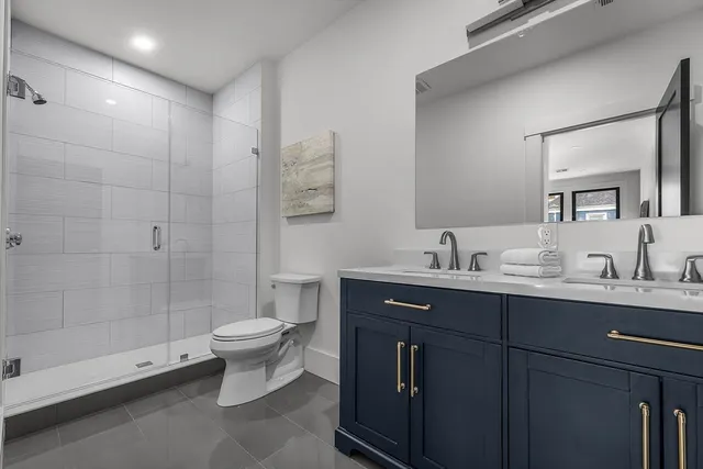 a bathroom with a sink toilet and shower