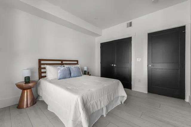 a bedroom with a bed and a mirror