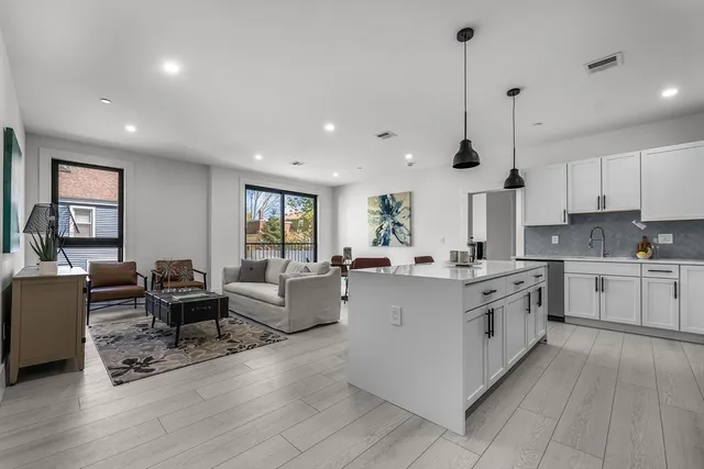 a large kitchen with stainless steel appliances lots of counter top space