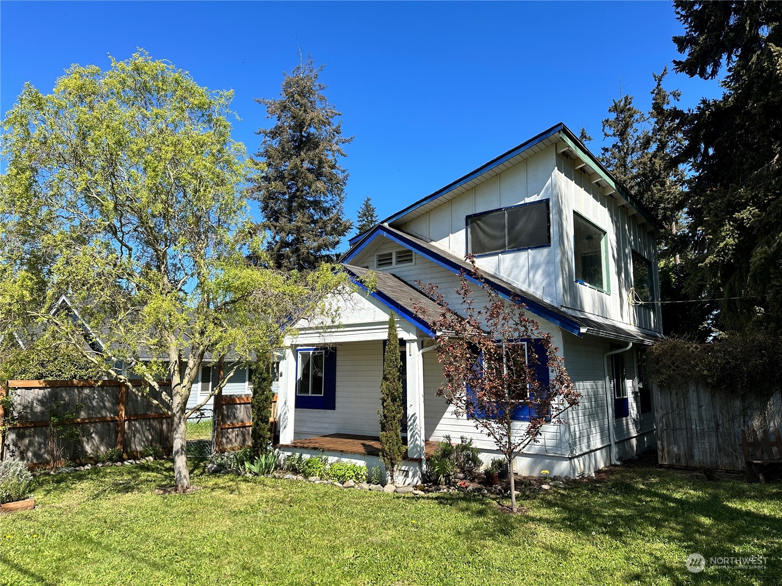a front view of house with yard and outdoor seating
