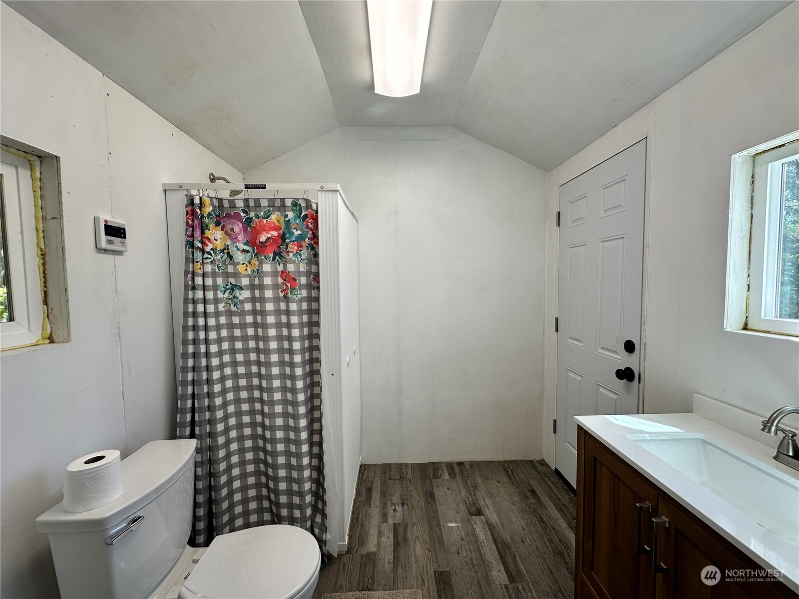 51 East Runnion Road Sequim, WA 98382 - Photo 23 of 40 a bathroom with a toilet sink vanity and shower