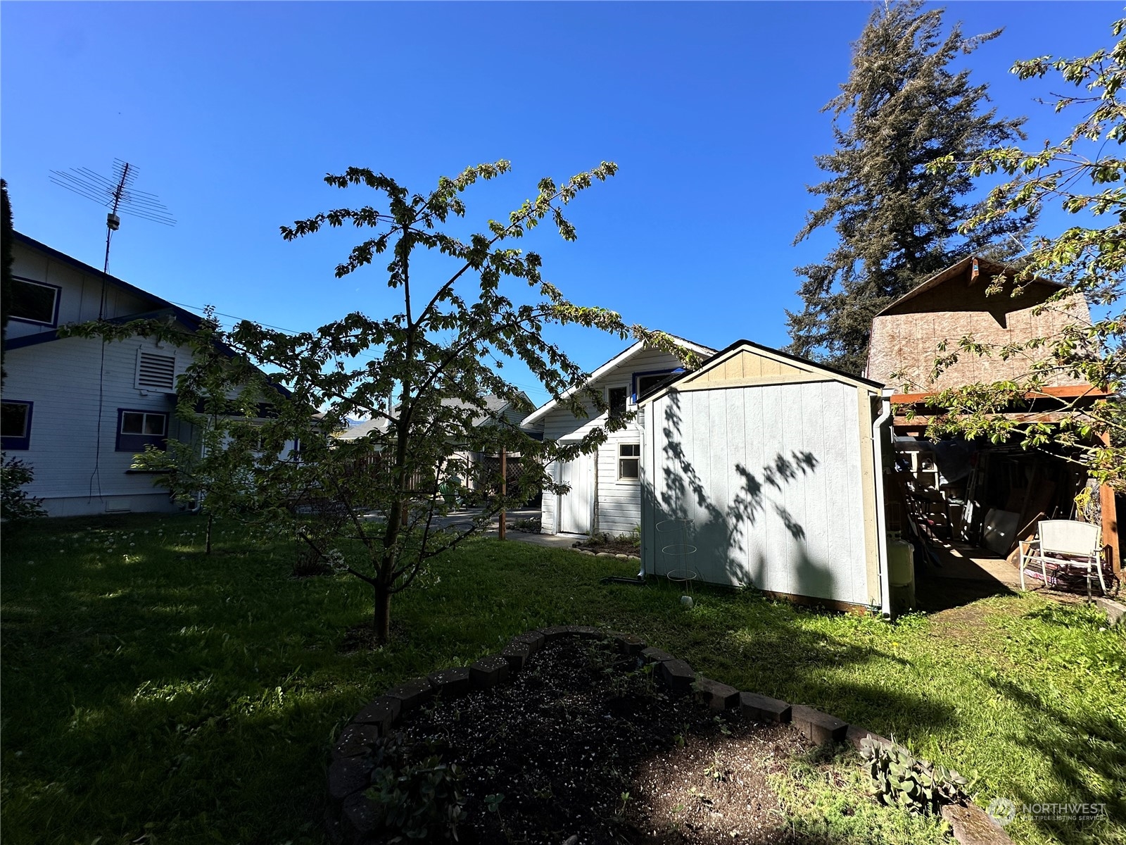 51 East Runnion Road Sequim, WA 98382 - Photo 39 of 40 a view of a white house with a yard and garden