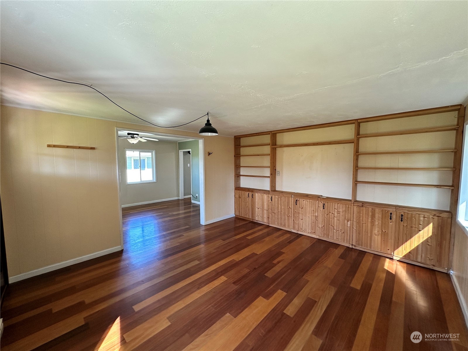 51 East Runnion Road Sequim, WA 98382 - Photo 5 of 40 a view of an empty room with wooden floor and a window