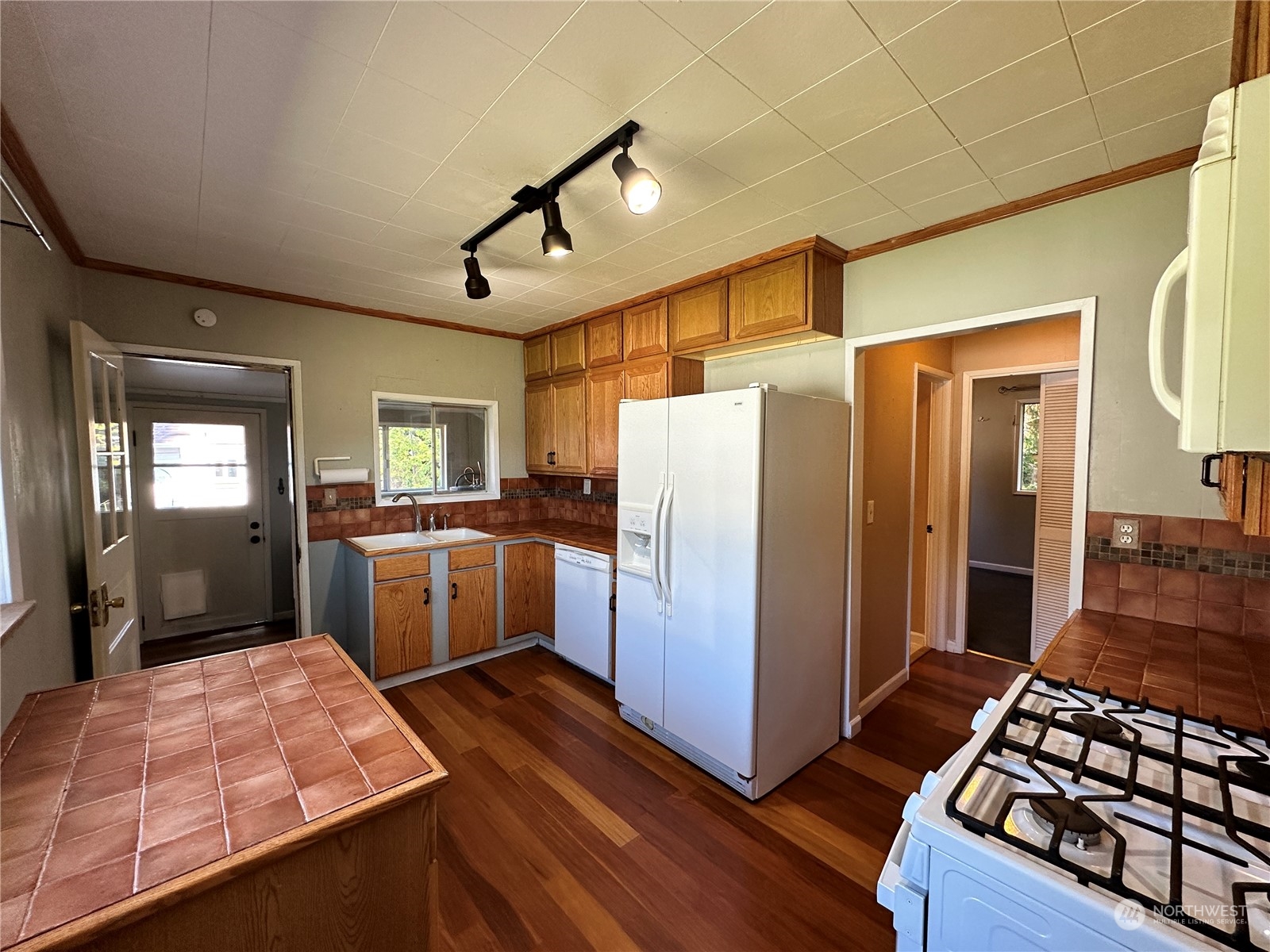 51 East Runnion Road Sequim, WA 98382 - Photo 8 of 40 a kitchen with sink cabinets and wooden floor