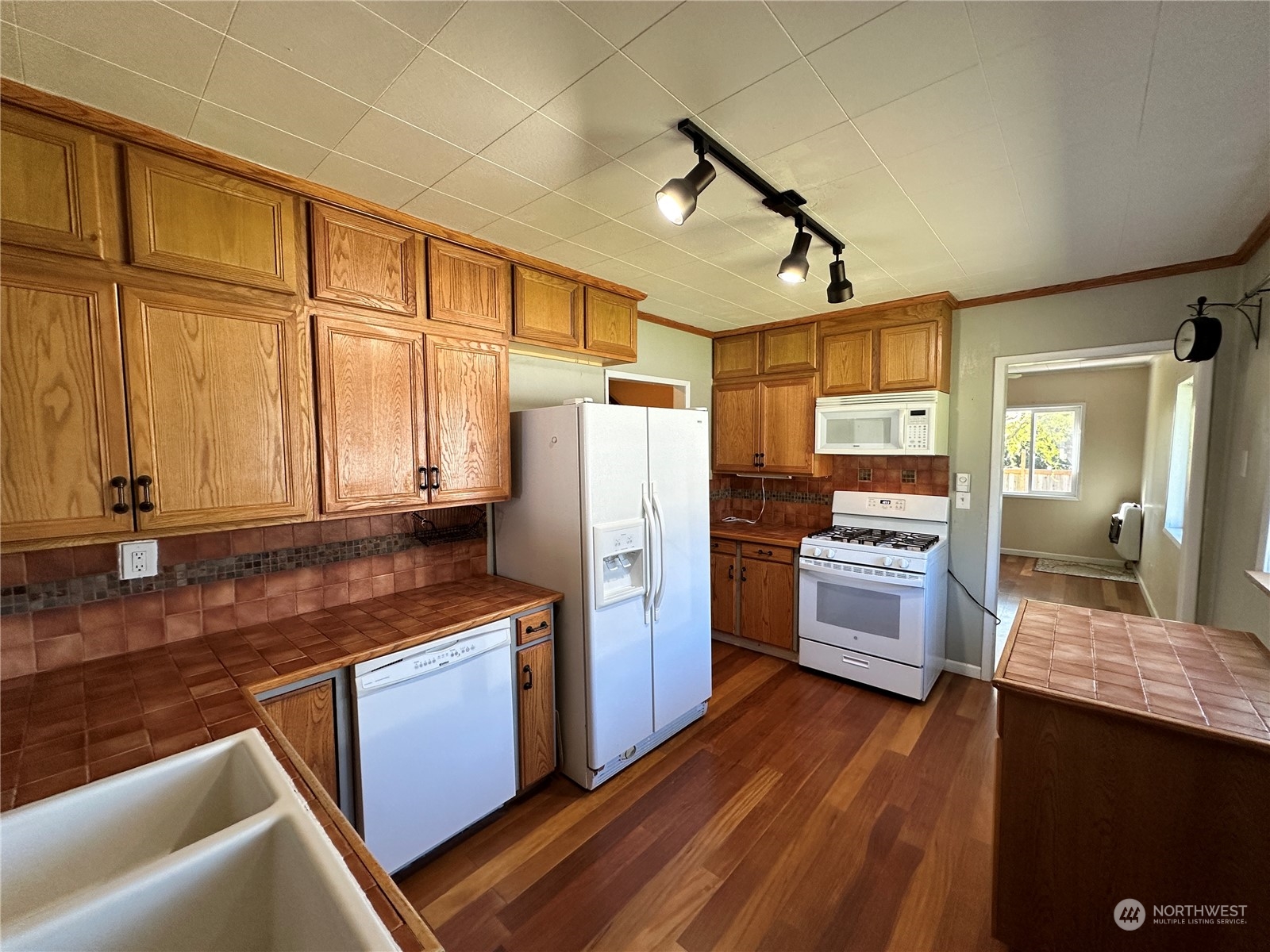 51 East Runnion Road Sequim, WA 98382 - Photo 9 of 40 a kitchen with refrigerator cabinets and wooden floor
