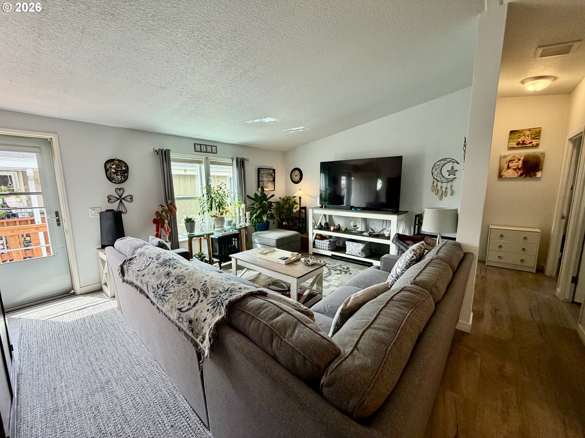 1699 North Terry Street, Unit 351 Eugene, OR 97402 - Photo 14 of 23 a living room with furniture and a flat screen tv