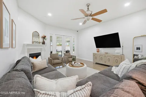 a living room with furniture a fireplace and a flat screen tv